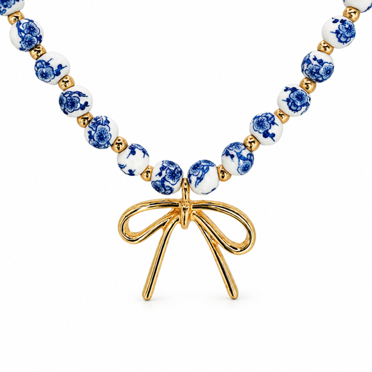 Bow & Chinoiserie Beaded Necklace — luxury white background product photo