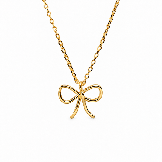 Mini Baby Bow Gloss Necklace — luxury white background product photo